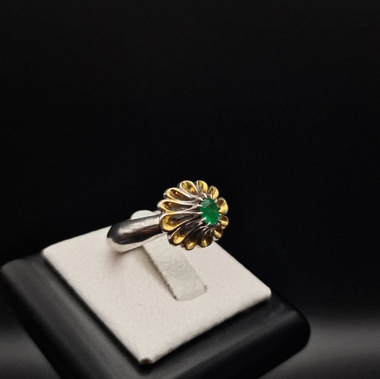 side view from an emerald Silver Ring with golden floral design. by Haidar and Co. Boutique